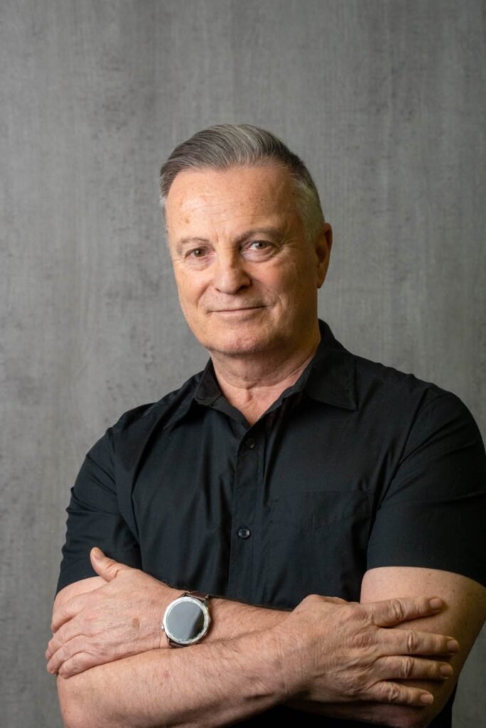 Executive headshot on a grey backdrop